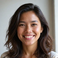 Portrait of a friendly, diverse team member smiling, in a bright, natural setting.