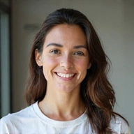 Portrait of a friendly, diverse team member smiling, in a bright, natural setting.