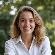 Portrait of a friendly, diverse team member smiling, in a bright, natural setting.